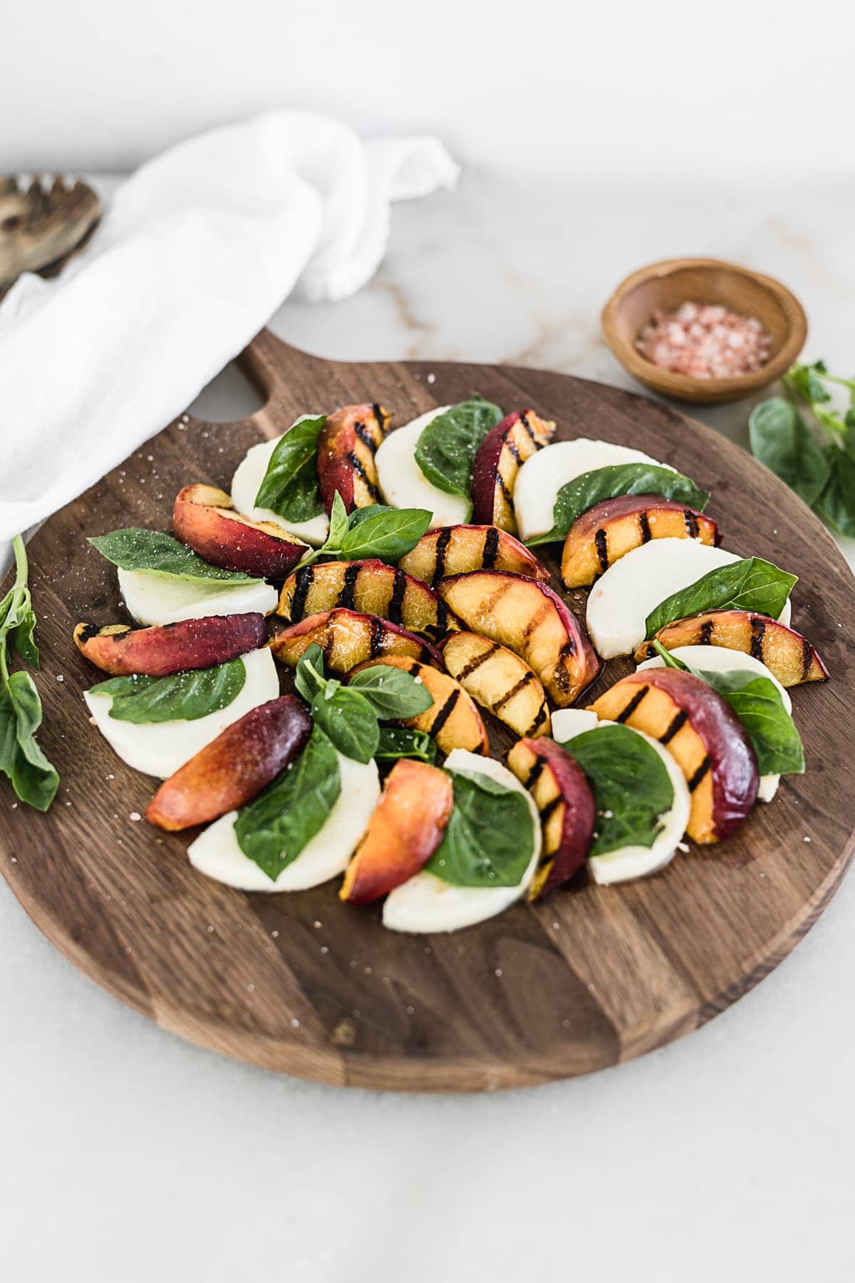 Grilled Peach Caprese is a delightful way to enjoy juicy summer peaches and fresh mozzarella! It's a healthy and gluten free summer salad that you will love. | via livelytable.com