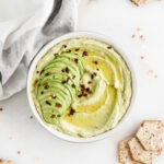 Overhead view of avocado hummus in a bowl.