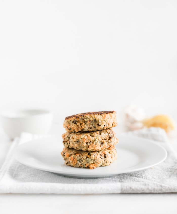 easy quinoa salmon burger patties stacked on a plate