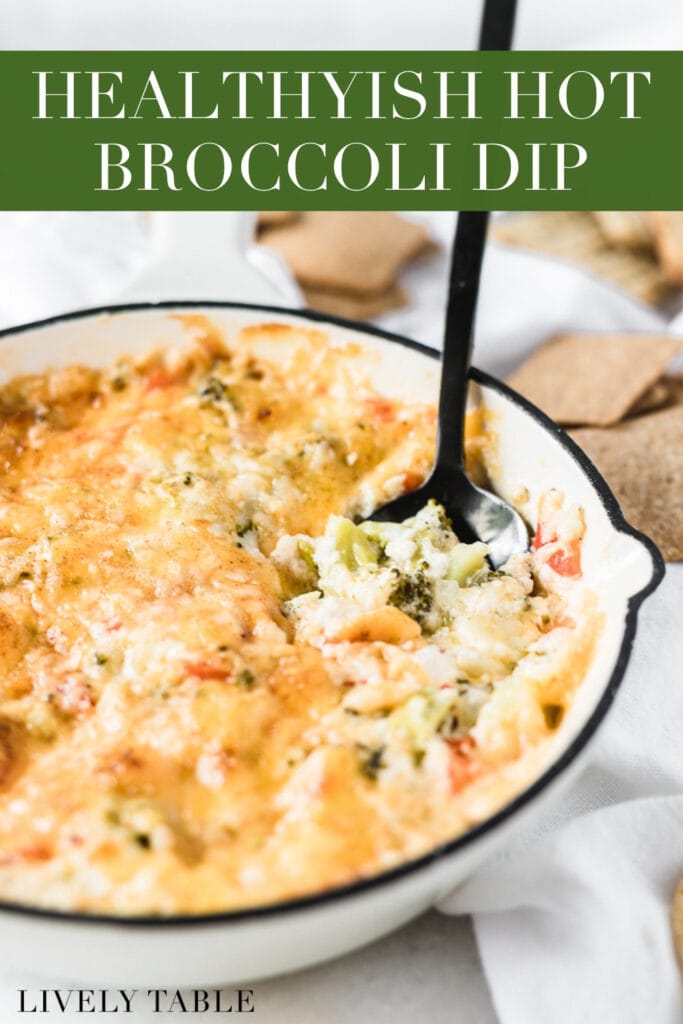 hot broccoli dip in a white skillet with a spoon in it with text overlay.