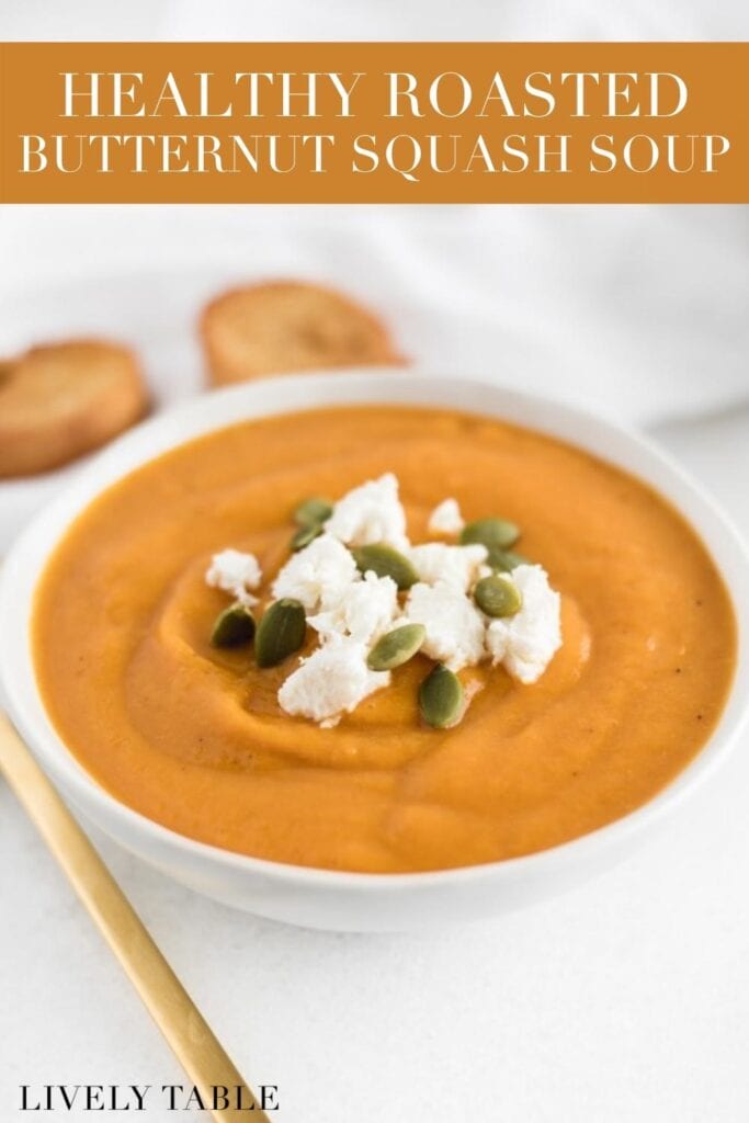 bowl of butternut squash soup topped with goat cheese and pepitas with text overlay.