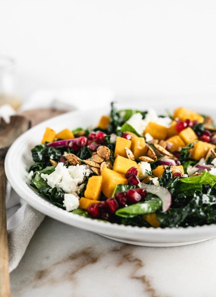 Butternut squash salad with kale, spinach, pomegranate, onions, and feta cheese.