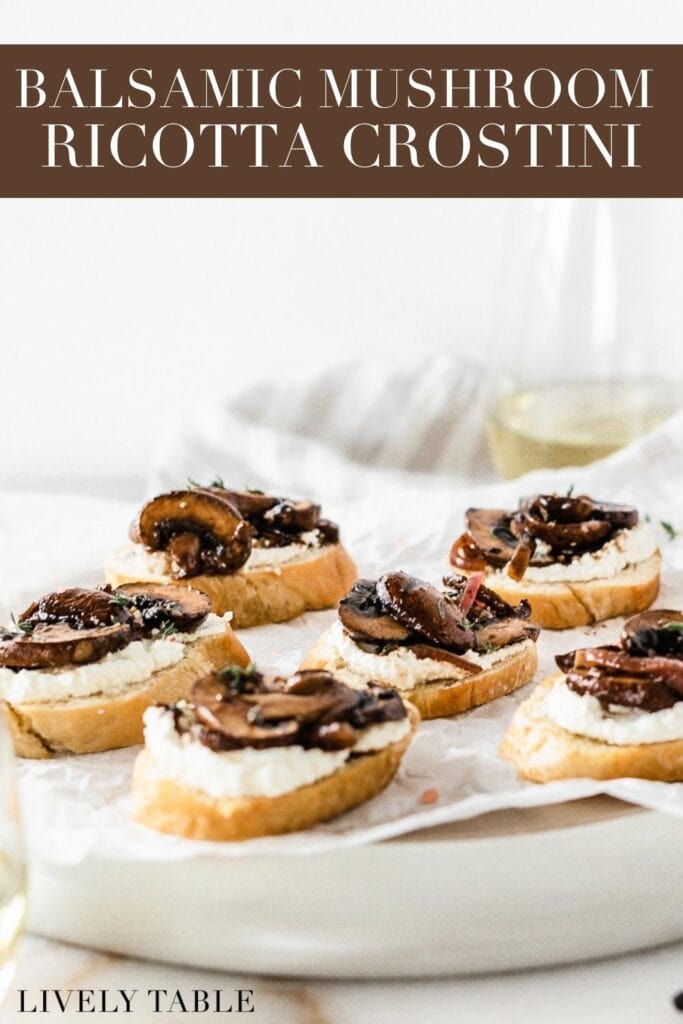 mushroom ricotta crostini on a serving platter surrounded by wine glasses with text overlay.