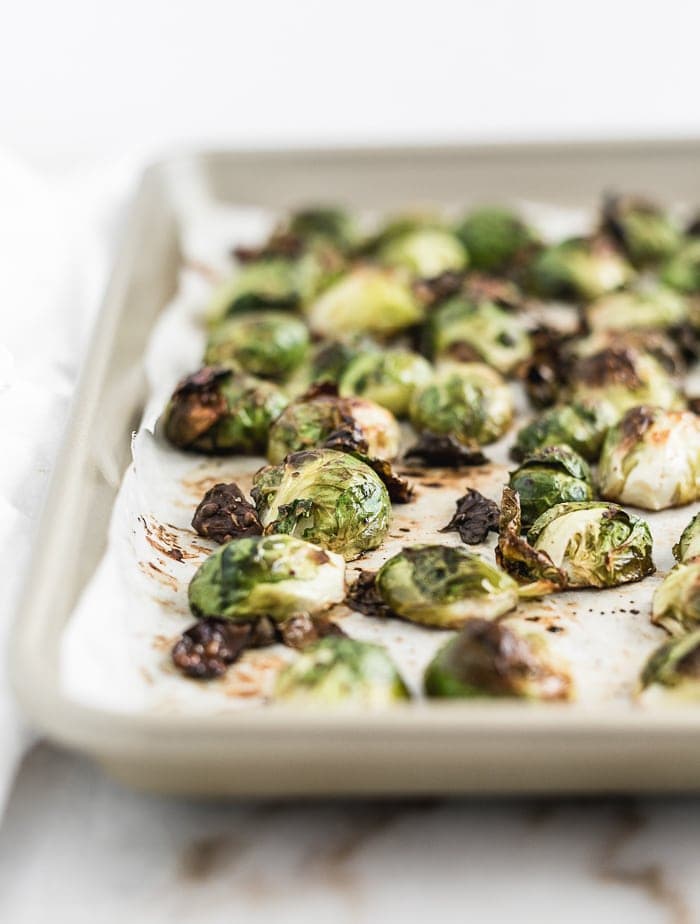 closeup of roasted brussels sprouts on a baking sheet.