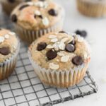 Healthy gluten free banana chocolate chip blender muffin on a cooling rack.