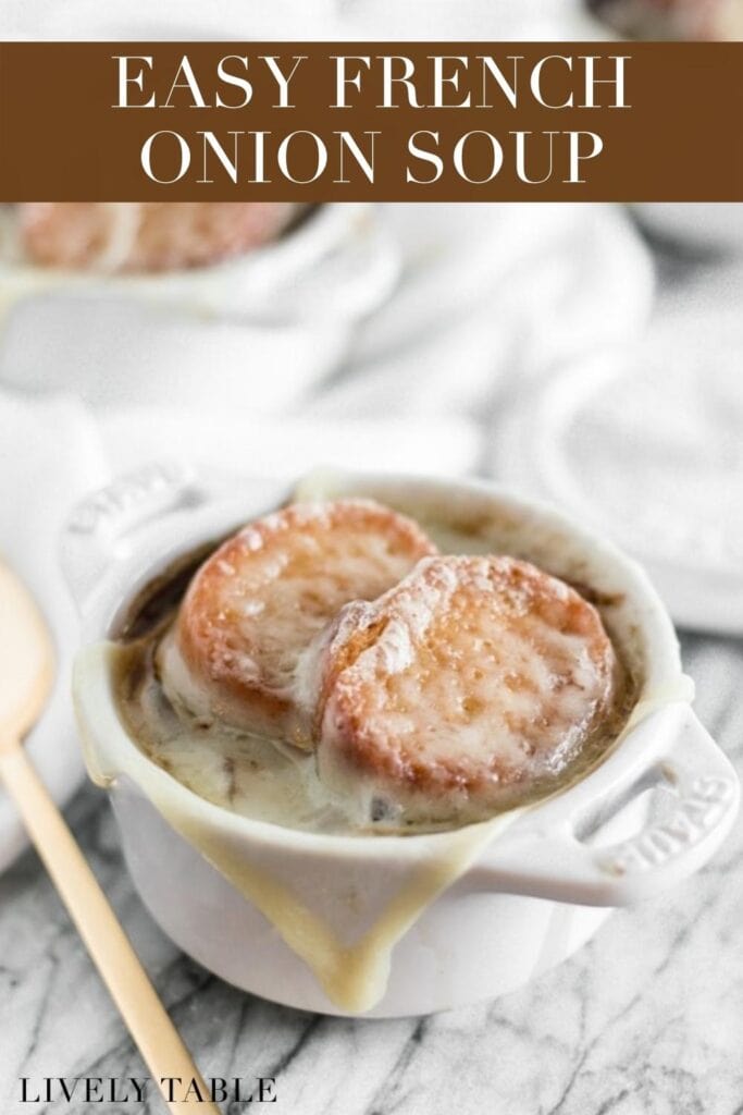 small white ramekin on french onion soup topped with crostini and melted cheese with text overlay.