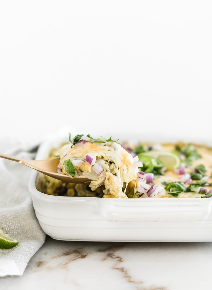 A spoon full of chicken enchilada quinoa casserole.