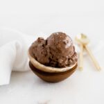 closeup of dark chocolate avocado frozen yogurt in wooden bowls.