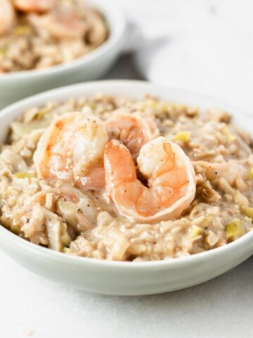 closeup of a bowl of shrimp and leek brown rice risotto.