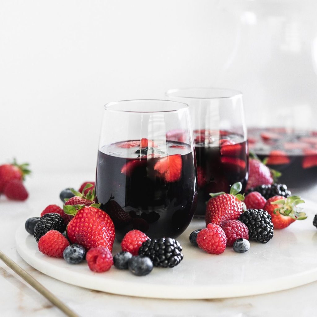 Antioxidant berry Sangrias on a tray with berries.