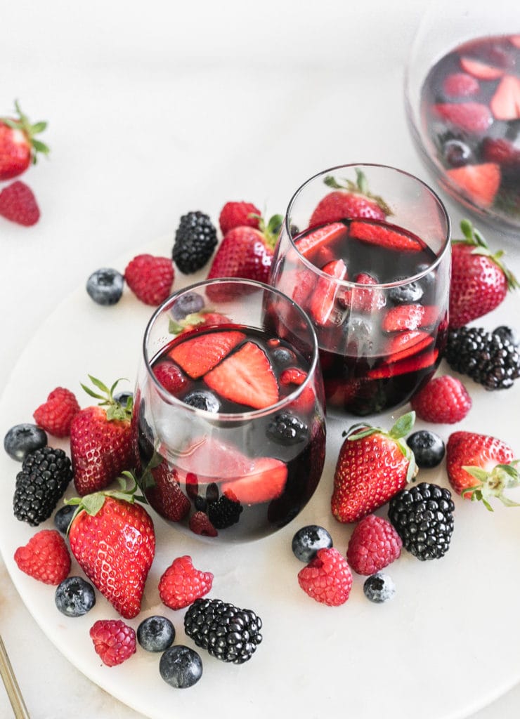 Antioxidant red berry Sangrias on a tray with berries.