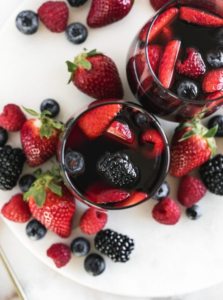 Close up top view of antioxidant red berry Sangrias on a tray with berries.
