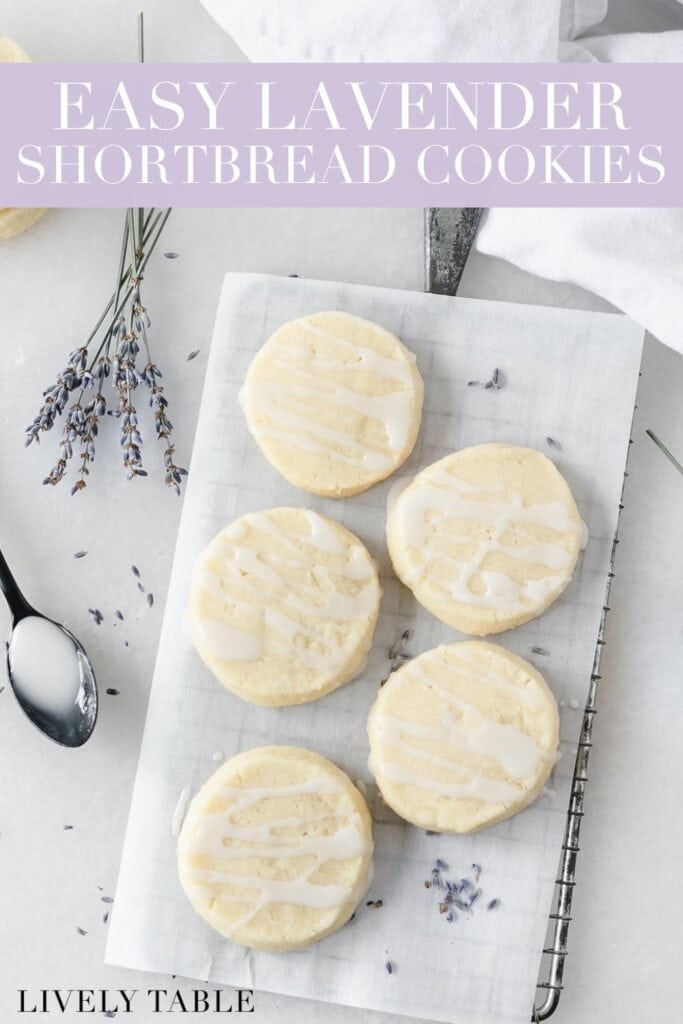 overhead view of lavender shortbread cookies on a wire cooling rack surrounded by dried lavender and a spoonful of lavender glaze with text overlay.