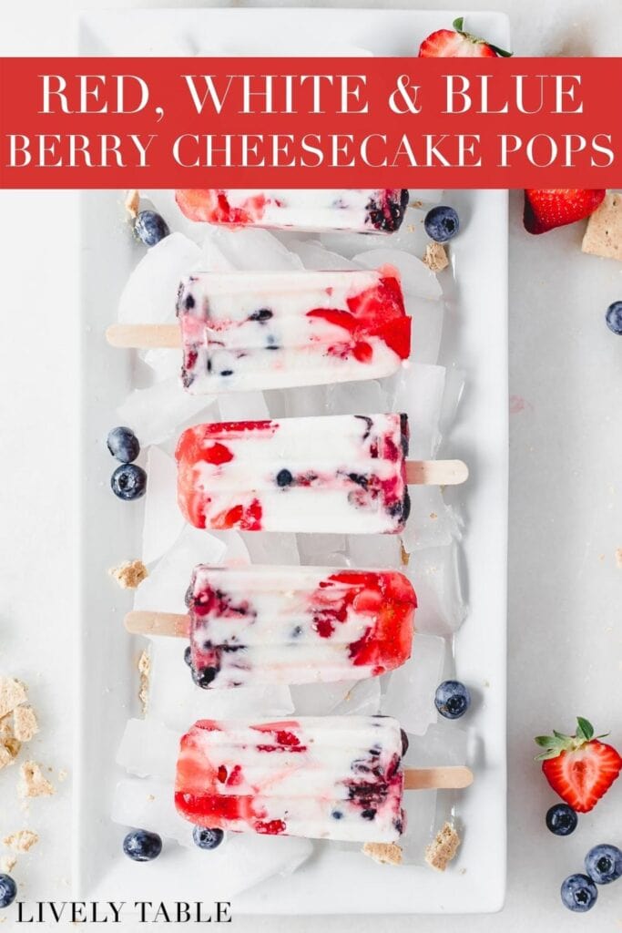 overhead view of red white and blue berry cheesecake popsicles on a platter with ice, berries and crushed graham crackers with text overlay.