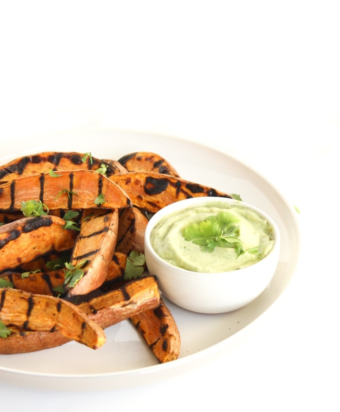 Grilled sweet potato wedges with avocado cream sauce for dipping are the perfect easy, healthy side dish to go with burgers, grilled chicken and more! (vegetarian, gluten-free) | via livelytable.com