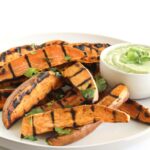 Grilled sweet potato wedges with avocado cream sauce for dipping are the perfect easy, healthy side dish to go with burgers, grilled chicken and more! (vegetarian, gluten-free)