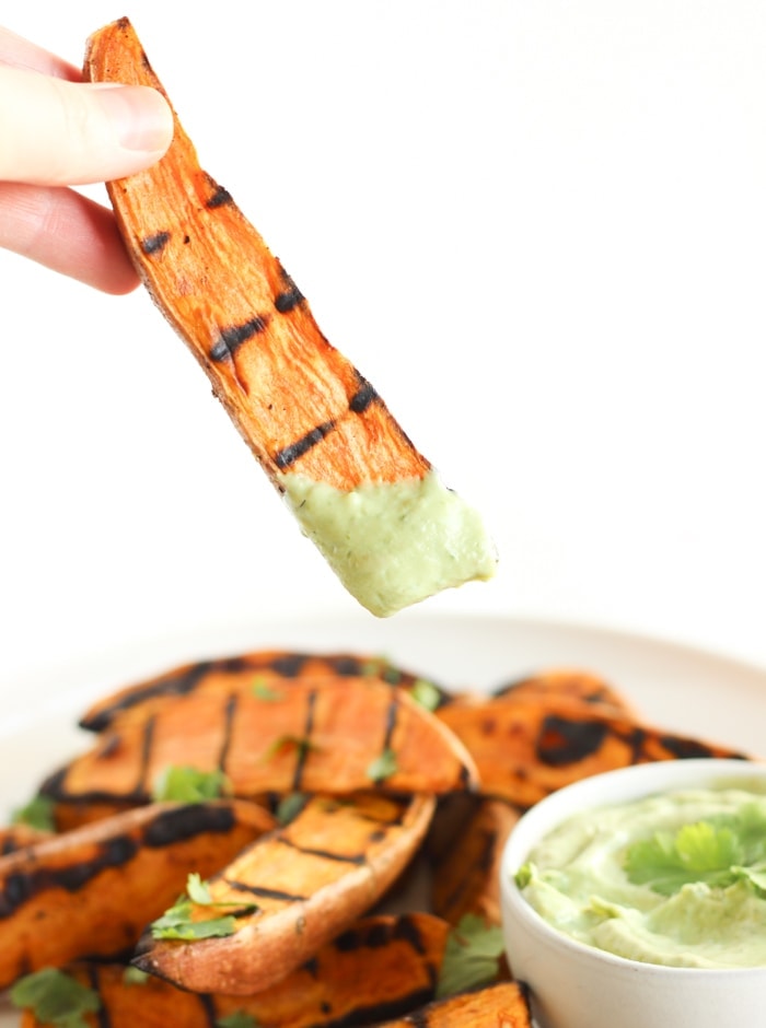 Grilled sweet potato wedges with avocado cream sauce for dipping are the perfect easy, healthy side dish to go with burgers, grilled chicken and more! (vegetarian, gluten-free) | via livelytable.com
