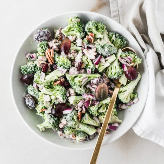 overhead view of no mayo broccoli salad with a gold fork in it.