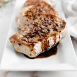 Skillet Pork Chops with Balsamic Glaze on a white square plate.