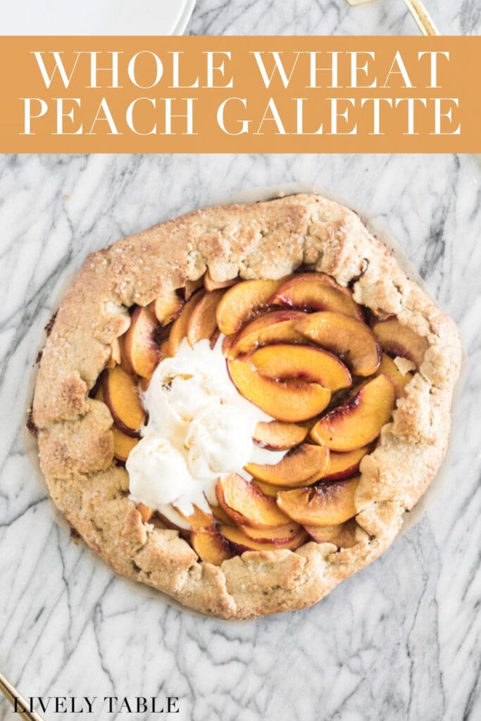 overhead view of peach galette with ice cream on top on a marble backdrop with text overlay.