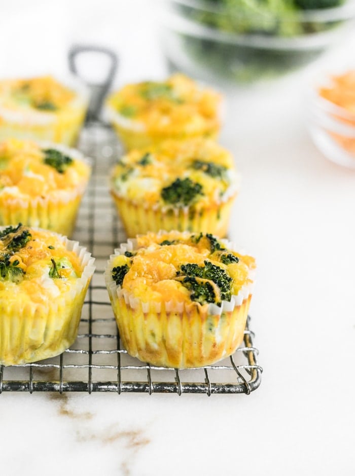 Broccoli Cheddar Egg Muffins on a wire cooling rack.