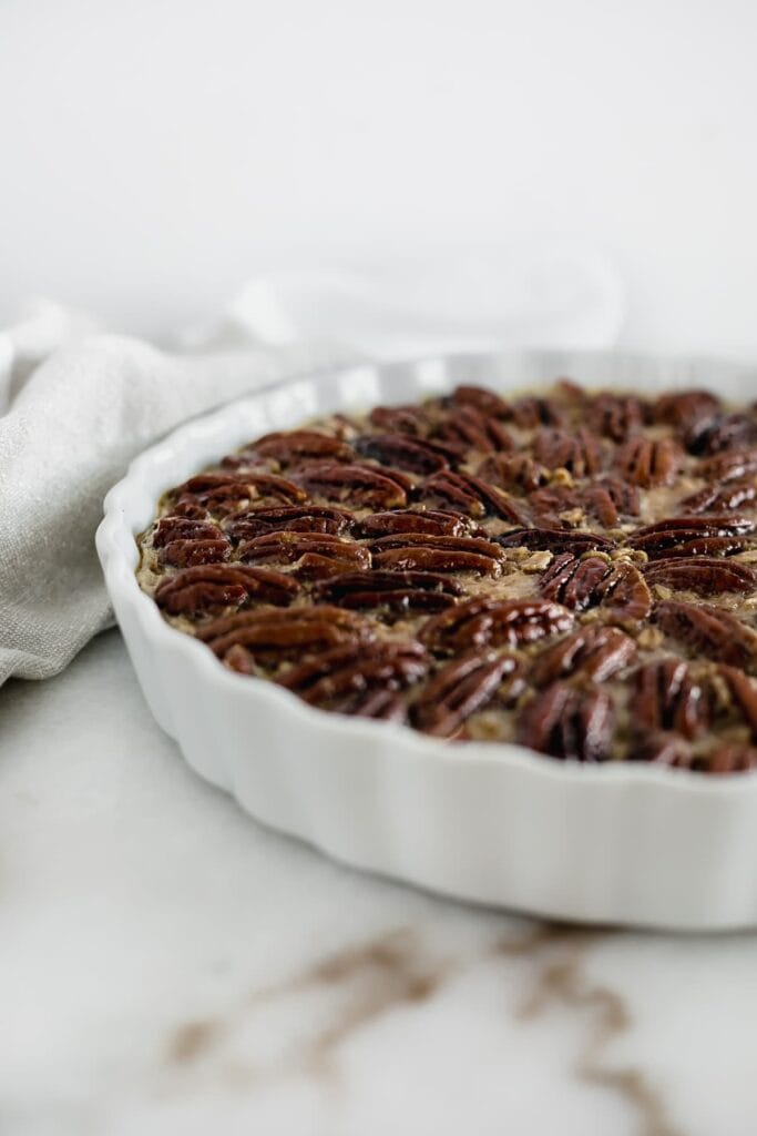 Healthy pecan pie baked oatmeal in a baking pan.