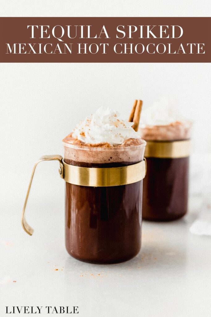 mug of tequila spiked mexican hot chocolate topped with whipped cream with text overlay.