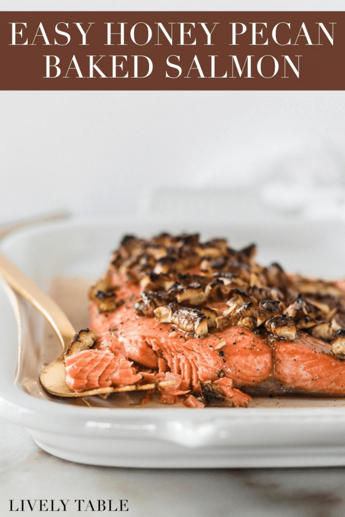 closeup of honey pecan salmon filet flaked on the corner with a gold fork beside it with text overlay.