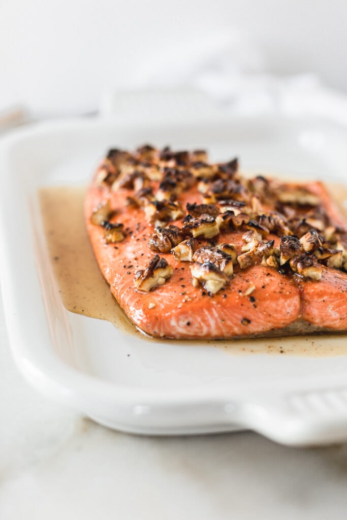 closeup of honey pecan salmon on a white platter.