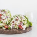 wedge salad on a wooden serving board.