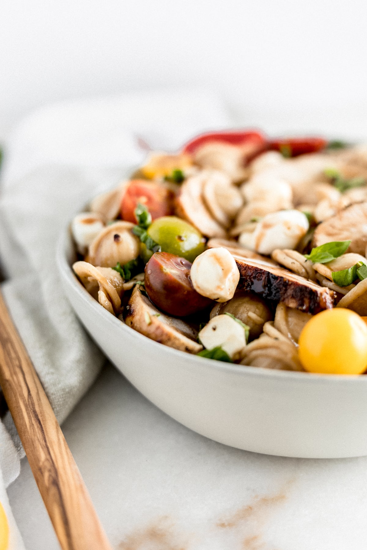 Chicken Caprese pasta salad in a bowl.