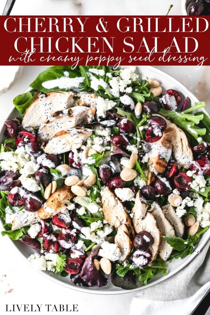 overhead view of salad with grilled chicken, cherries, almonds and poppy seed dressing on a white plate with text overlay.
