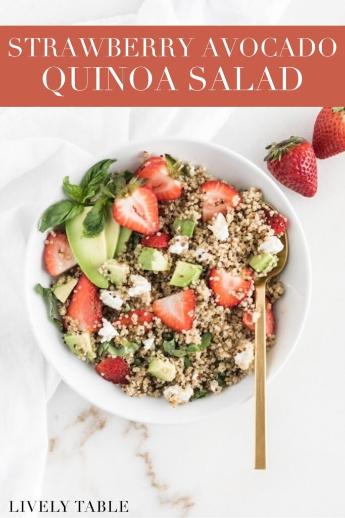 overhead view of strawberry avocado quinoa salad in a white bowl with a gold spoon in it with text overlay.