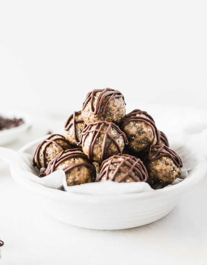 Quinoa Peanut Butter Cup Protein Balls stacked in a round white dish.