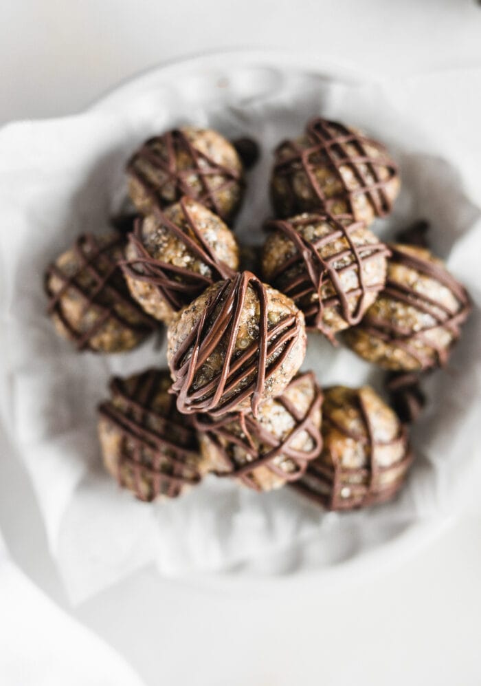 overhead view of Quinoa Peanut Butter Cup Protein Balls stacked in a white dish.