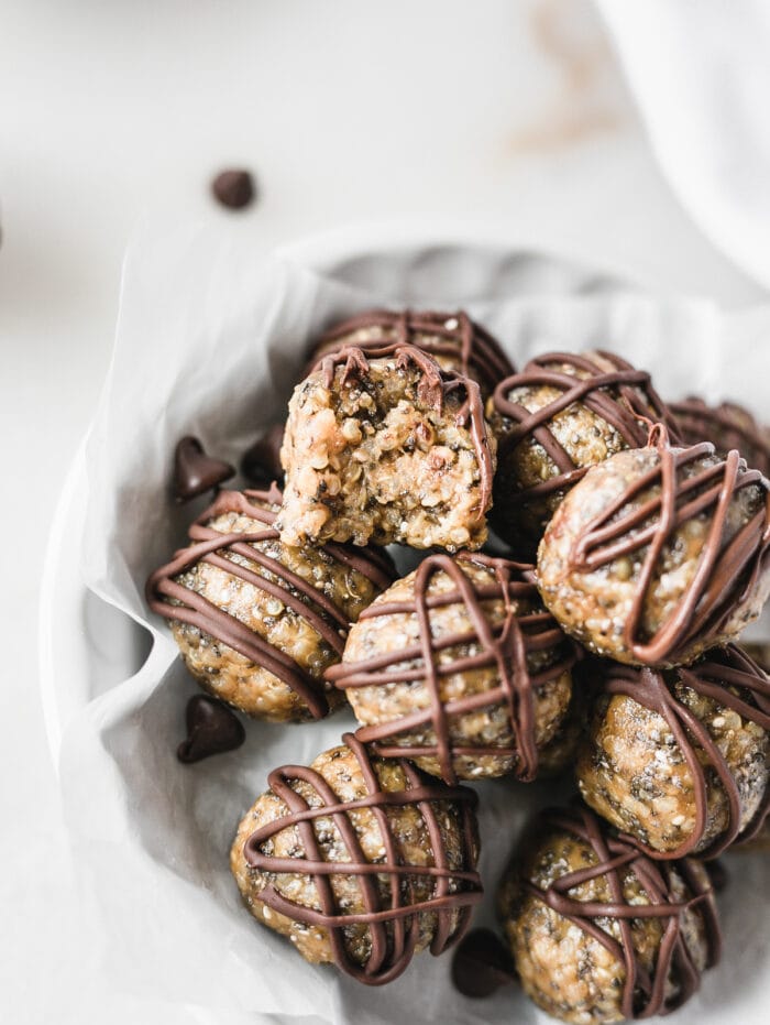 close up of a peanut butter cup protein balls in a stack with a bite taken out of one.