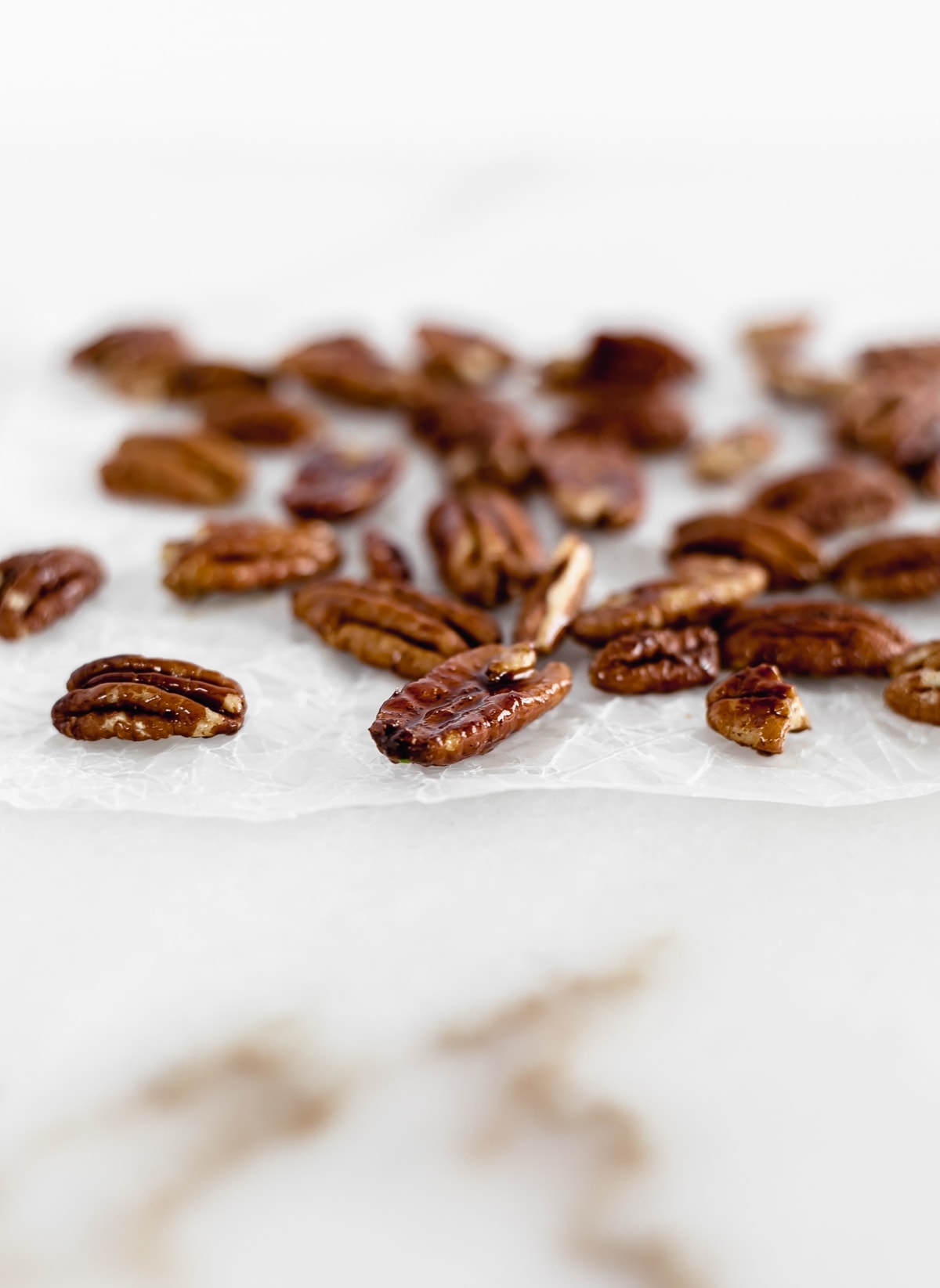 Easy 3 Ingredient Candied Pecans are sweet, crunchy, and perfect for the holidays! Add them to salads, oatmeal, or just snack on them. (gluten-free, refined sugar-free, vegan)