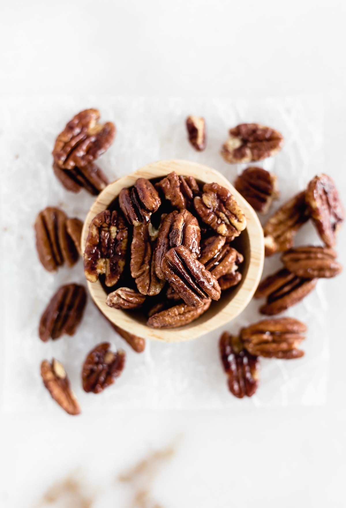 Easy 3 Ingredient Candied Pecans are sweet, crunchy, and perfect for the holidays! Add them to salads, oatmeal, or just snack on them. (gluten-free, refined sugar-free, vegan)
