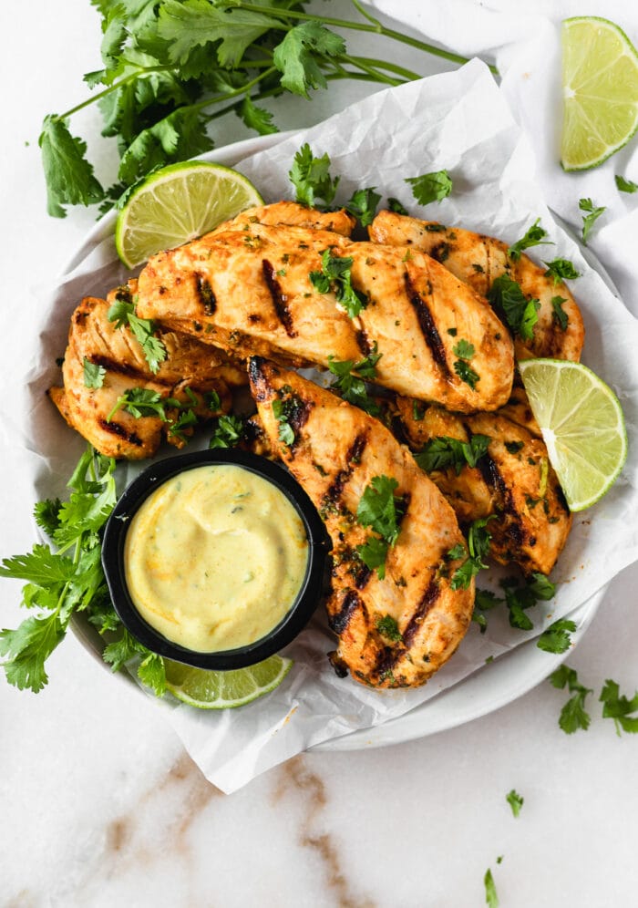 overhead view of Thai Coconut grilled Chicken Tenders With Coconut Turmeric Dipping Sauce on a plate.