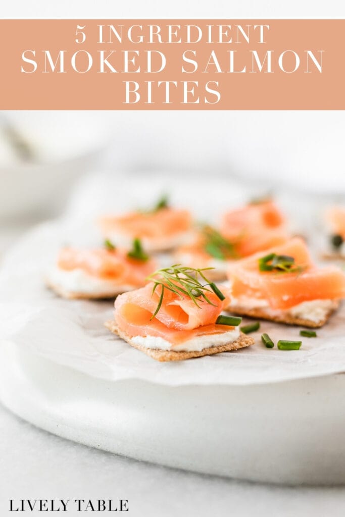smoked salmon bites topped with fresh herbs on a white parchment covered plate with text overlay.
