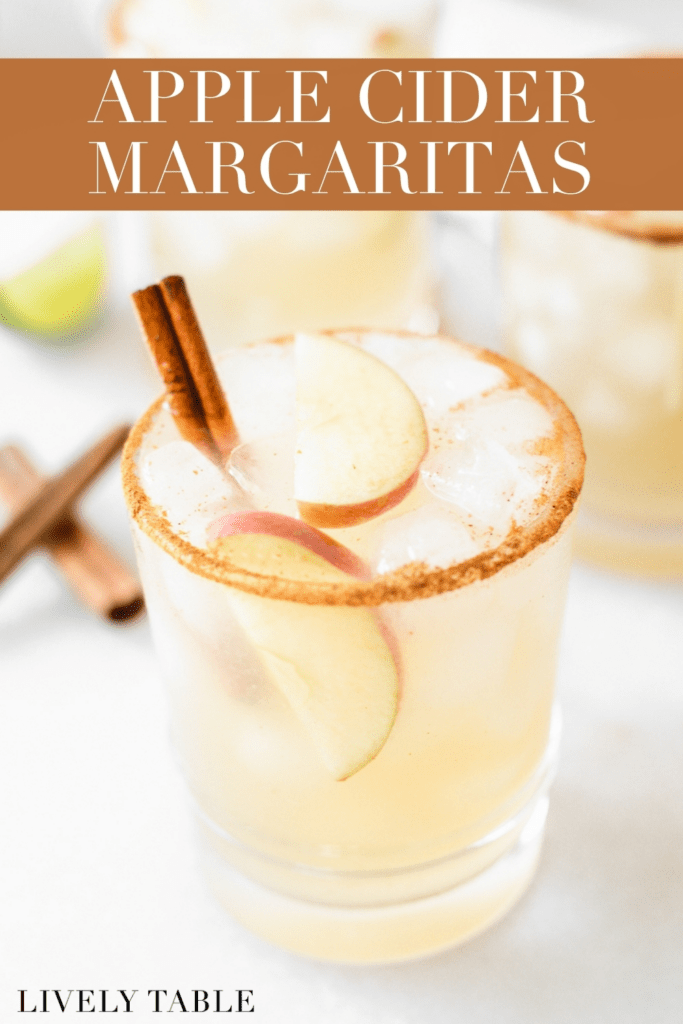 apple cider margarita with apple slices and a cinnamon stick in it with text overlay.