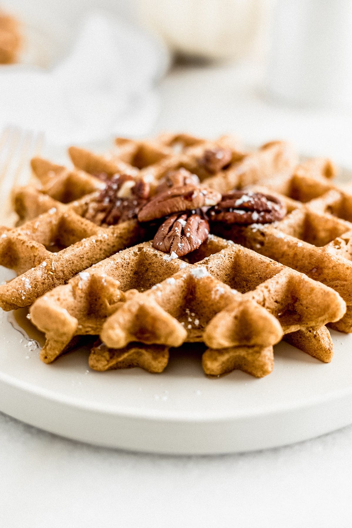 Healthy whole wheat pumpkin waffles with crispy outsides and fluffy, spiced insides are the perfect fall breakfast to wake up to on weekends!  (dairy-free, vegetarian, no added sugar)