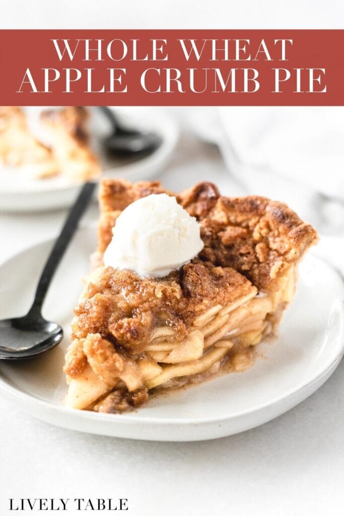 slice of apple crumb pie with a scoop of ice cream on top on a plate with a black spoon with text overlay.