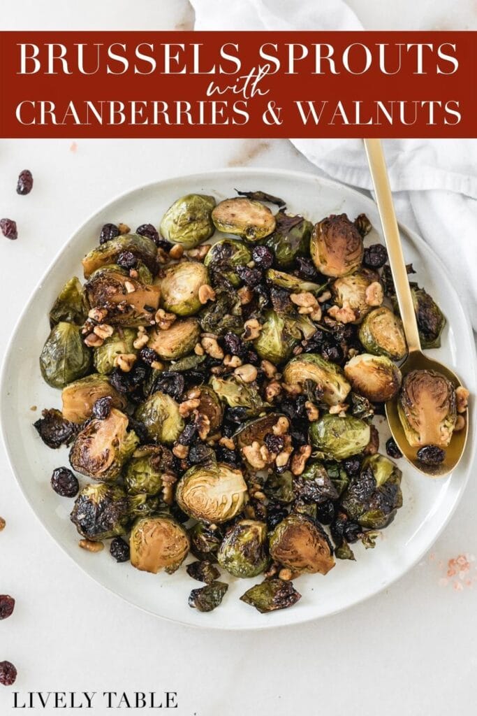roasted brussels sprouts with cranberries and walnuts on a plate with a gold spoon with text overlay.