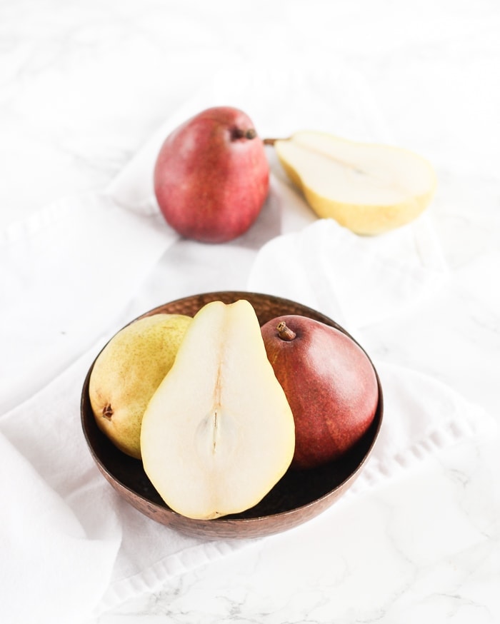 Naturally sweetened slow cooker vanilla bean pear butter is the perfect way to use up a bunch of pears! It's easy, low sugar and delicious with everything from oatmeal and pancakes to pork loin and cheese platters. (Includes canning instructions.) gluten-free, nut-free, dairy-free
