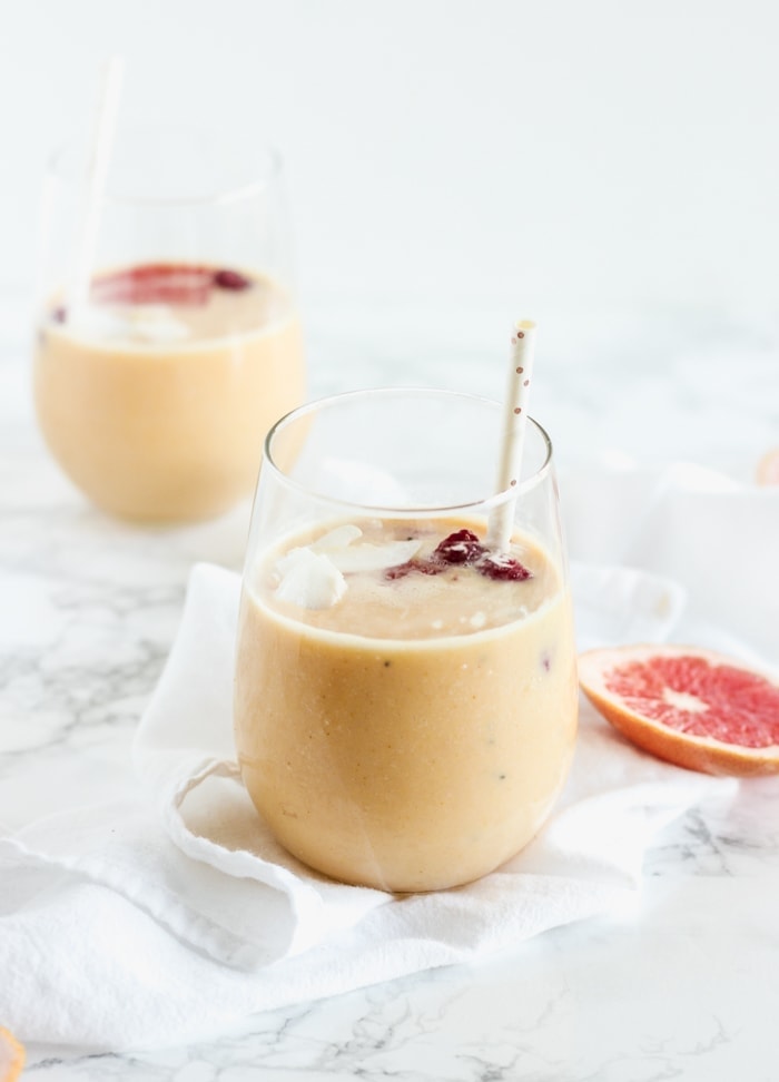 nutrient-packed immune-boosting grapefruit mango smoothie with turmeric in 2 glasses