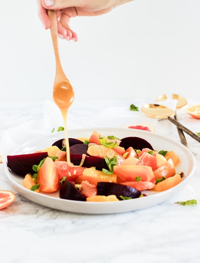 honey drizzled over Citrus beet salad with pistachios and mint