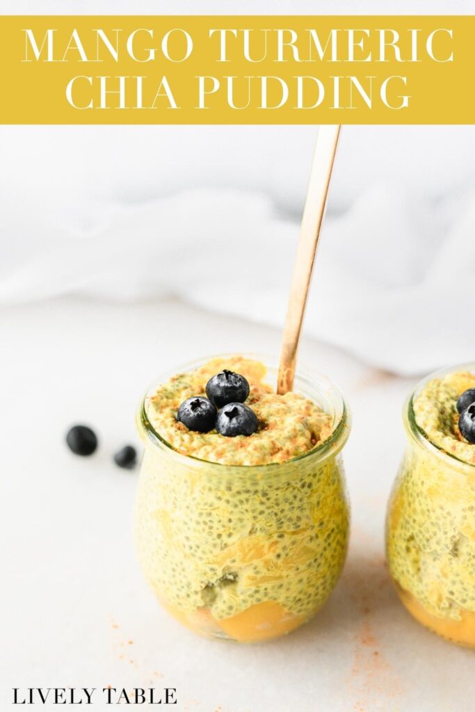mango turmeric chia pudding in a glass jar with blueberries on top and a gold spoon in it with text overlay.
