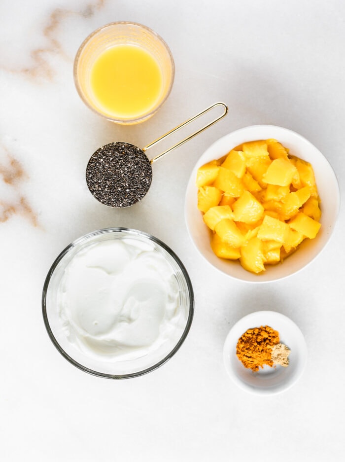 overhead view of ingredients needed to make mango turmeric chia pudding.