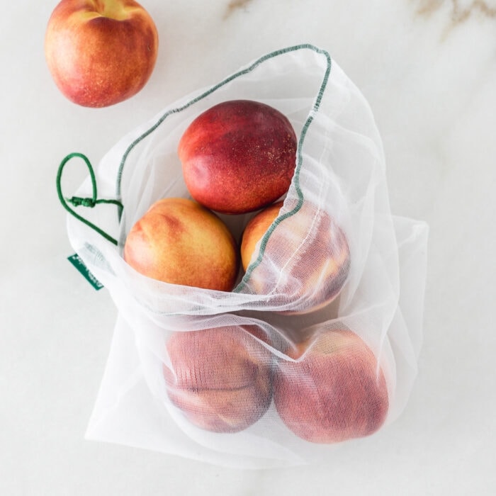 peaches in a mesh produce bag.